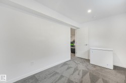 Room with neutral wall paint and patterned carpet flooring - 