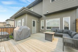 Spacious wood-finish deck with dark metal railing - 