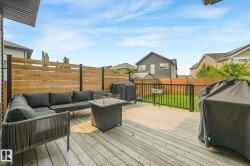 Spacious wooden deck with a horizontal slatted privacy fence - 