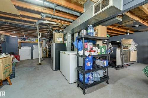 Basement area featuring a concrete floor, exposed wood ceiling joists, and visible ductwork - 11414 88 Street Nw, Edmonton, AB 