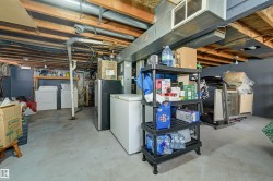 Basement area featuring a concrete floor, exposed wood ceiling joists, and visible ductwork - 