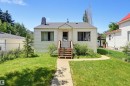 Traditional single-story residence featuring light-colored siding, a dark shingle roof, and a prominent front entryway with wooden stairs - 11414 88 Street Nw, Edmonton, AB 