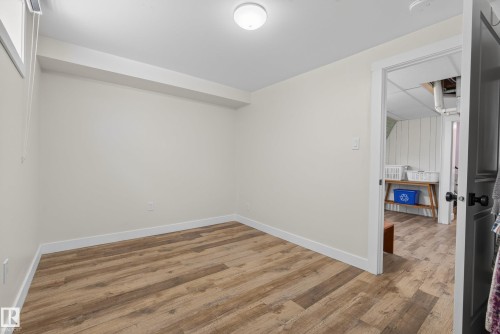 Neutral wall tones with wood-finish flooring - 14128 73 Street, Edmonton, AB 