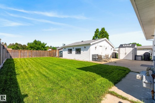 Expansive grassy yard with a wooden privacy fence - 14128 73 Street, Edmonton, AB 