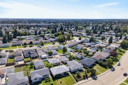 Residential neighborhood with detached homes, mature trees, and paved streets - 