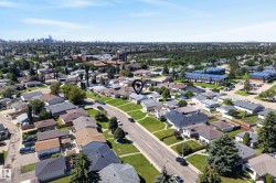 Aerial perspective showcasing a residential neighborhood with a distant cityscape - 