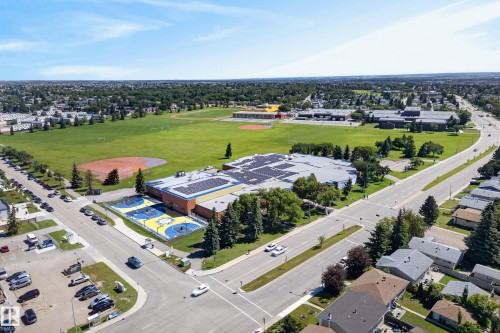 Aerial perspective showcasing a broad neighborhood with extensive green spaces - 14128 73 Street, Edmonton, AB 