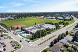 Aerial perspective showcasing a broad neighborhood with extensive green spaces - 