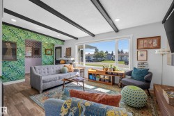 Spacious living area featuring exposed ceiling beams, recessed lighting, and wood-finish flooring - 