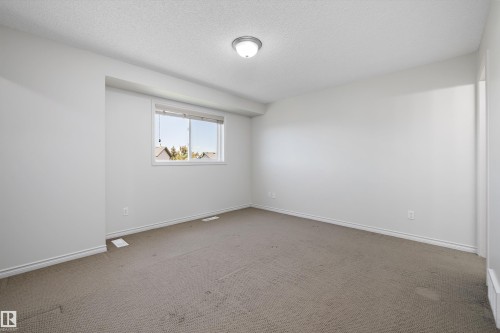 Bright room featuring neutral wall paint, a single window with blinds, and light-colored carpeting - 101 13825 155 Avenue, Edmonton, AB 