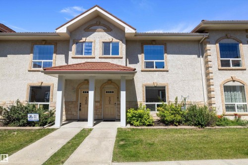 Multi-unit property with stucco exterior and prominent individual entryways - 101 13825 155 Avenue, Edmonton, AB 