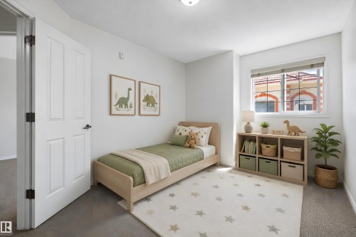 This room features a neutral color palette, recessed window, and a paneled interior door with dark hardware - 101 13825 155 Avenue, Edmonton, AB 