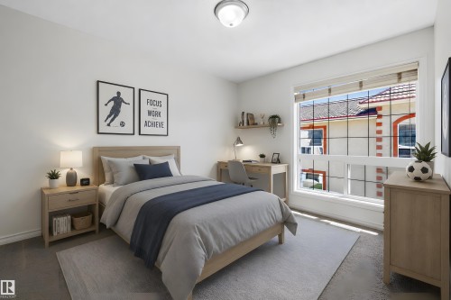 Spacious room featuring a large window, neutral wall tones, and overhead lighting - 101 13825 155 Avenue, Edmonton, AB 