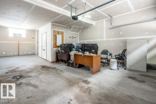 Concrete flooring throughout this unfinished garage space - 96 1530 Tamarack Boulevard, Edmonton, AB 
