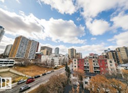 Urban skyline featuring diverse architectural styles and mature trees - 