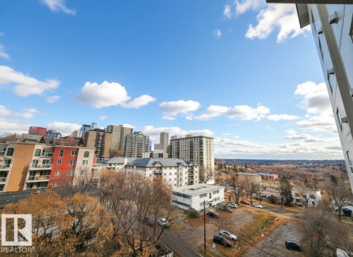 Cityscape featuring a mix of high-rise and mid-rise buildings, residential structures, and distant tree lines under a partly cloudy sky - 603 9707 105 Street, Edmonton, AB - Outdoor With View