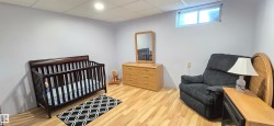 Light gray walls with recessed lighting and wood-finish flooring - 