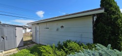 Detached structure with horizontal siding and a side entry door - 