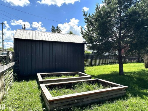 Metal-sided outbuilding with a corrugated metal roof - 825 2 Street, Thorhild, AB 