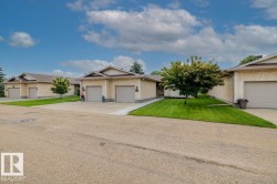 Exterior showcasing stucco siding, attached garages with sectional doors, and gabled roofs - 
