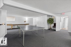Spacious recreation room featuring dark gray carpeting and recessed lighting - 