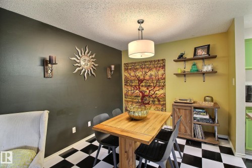 Dining area featuring a checkerboard floor and a wood-finish table - 30 14620 26 Street, Edmonton, AB 