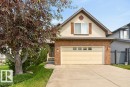 Single-family dwelling featuring brick and siding facade, an attached two-car garage with paneling, a concrete driveway, and a front entrance with steps - 572 Byrne Crescent, Edmonton, AB 