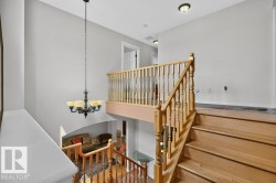 Hardwood staircase with traditional wood balusters and railing - 