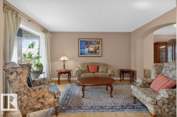 Bright living area featuring wood-finish flooring - 