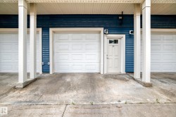 Exterior entrance featuring blue horizontal siding and white trim - 