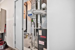 Utility room featuring a Goodman furnace and a whole-house humidifier - 