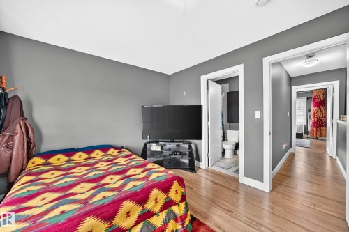 Light wood-finish flooring extending through the space - 37 13003 132 Avenue Nw, Edmonton, AB 