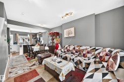 Expansive open-concept living area featuring wood-finish flooring, recessed lighting, and a neutral wall palette - 