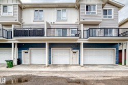 Multi-level exterior with light gray siding and dark blue lower level siding - 