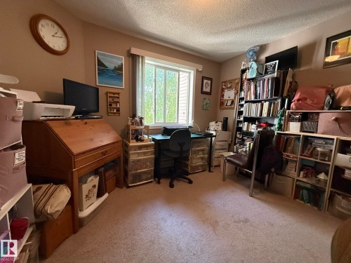 Carpeted room featuring a built-in window and wood-finish desk - 205 3425 19 Street, Edmonton, AB 