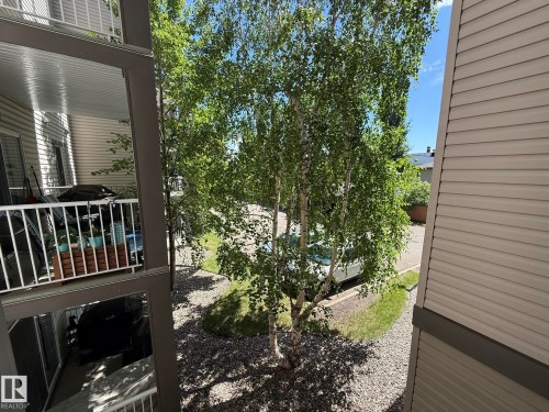 Balcony with white railing and privacy wall - 205 3425 19 Street, Edmonton, AB 