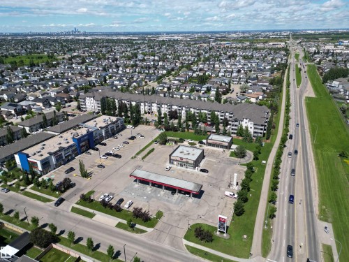 Aerial perspective showcasing commercial properties with extensive parking facilities - #205 3425 19 St Nw, Edmonton, AB - Outdoor With View