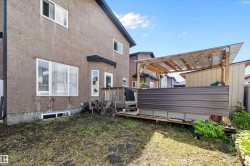 Rear exterior featuring a stucco facade and multiple windows - 