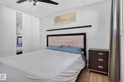 Bedroom featuring wood-finish flooring and a ceiling fan with integrated lighting - 
