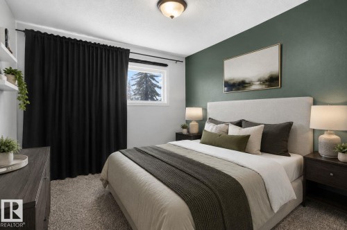 Bedroom featuring an accent wall, carpeted flooring, and a window with black privacy curtains - 7803 73 Street, Edmonton, AB 