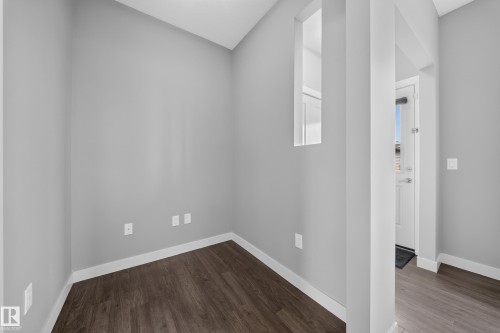 Interior room featuring wood-finish flooring and neutral gray walls - 2331 Casey Crescent Sw, Edmonton, AB 