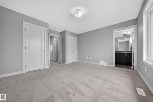 Spacious room with light gray walls and light-toned carpet flooring - 2331 Casey Crescent Sw, Edmonton, AB 