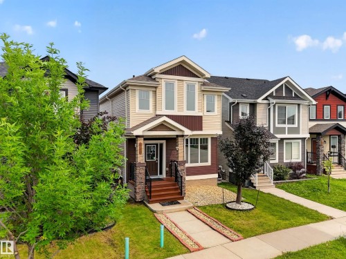 Two-story residence featuring a multi-toned facade, gabled rooflines, and a covered entryway - 2331 Casey Crescent Sw, Edmonton, AB 
