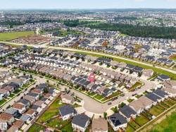 Residential neighborhood featuring a mix of detached and attached homes with diverse rooflines and landscaping - 