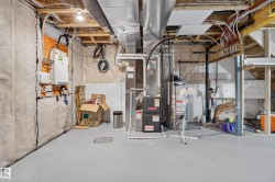Utility room featuring exposed framing, ductwork, and electrical conduits - 