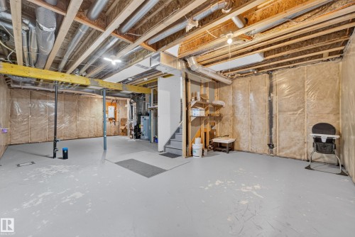 Unfinished basement featuring exposed ceiling joists and utility piping - 2331 Casey Crescent Sw, Edmonton, AB 