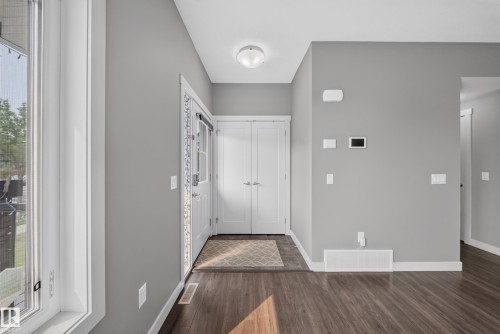 Entryway featuring wood-finish flooring, light grey painted walls, and white trim - 2331 Casey Crescent Sw, Edmonton, AB 