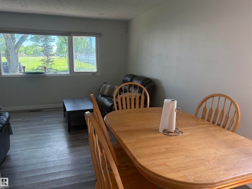 Bright interior space featuring a window wall, recessed lighting, and wood-finish flooring - 15922 92 Avenue, Edmonton, AB 