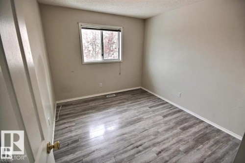 Neutral-toned walls complement the wood-finish flooring - 9457 156 Street, Edmonton, AB 
