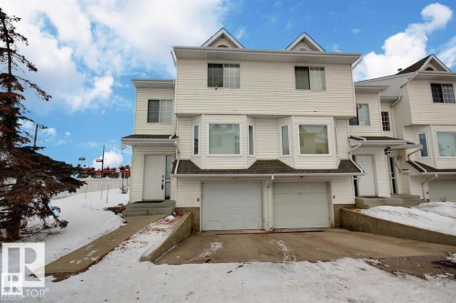White siding exterior with multiple bay windows and a dual-car garage - 9457 156 Street, Edmonton, AB 